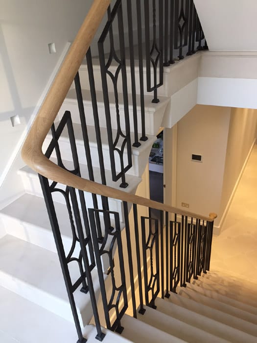 ExcelScarsdale-1 Elegant, continuous steel staircase balustrade with oak handrails