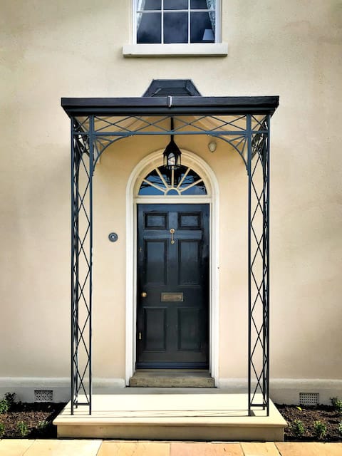 This stylish, yet traditional metal porch was created using our Regency Light ironwork and was paired with our curved and hipped roof frame which has been lined and finished in lead