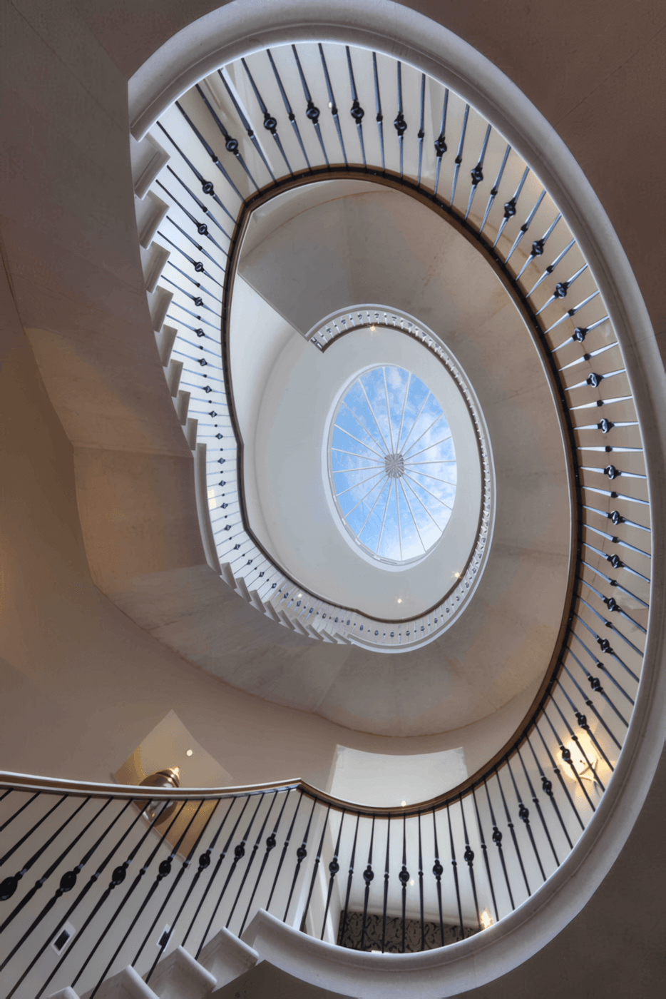 Metal Staircase serpentine balustrade glass atrium